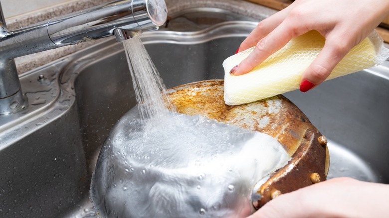 person washing pot