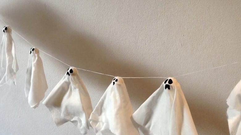 A garland filled with ghosts made of hardened tissues.
