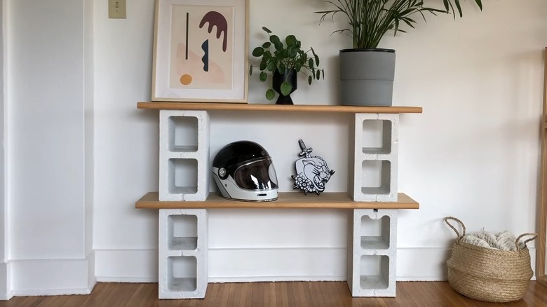 a two-level shelf built with leftover wood and concrete blocks