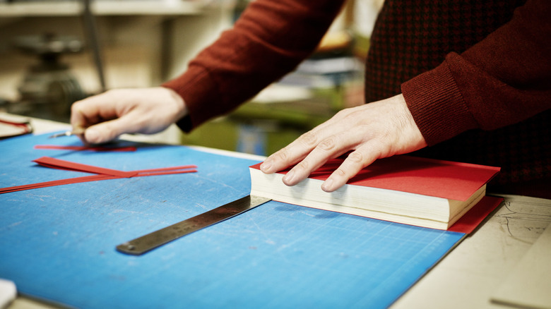 Person working with book on counter