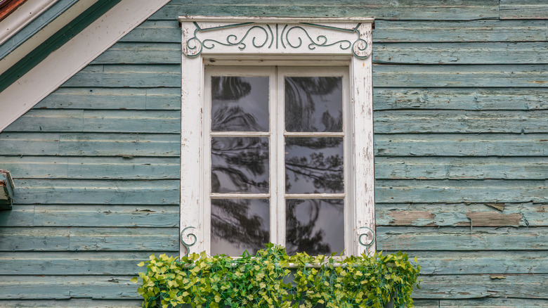 Turquoise house with old white window