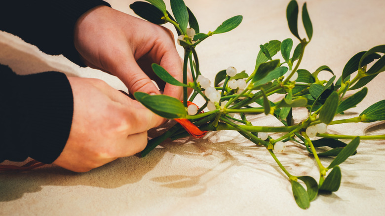 A hand prepares Christmas decorations
