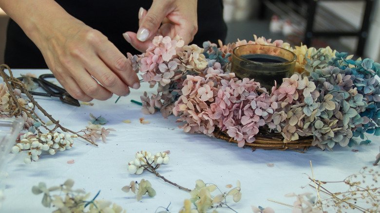 Making wreaths with dried hydrangea flowers.