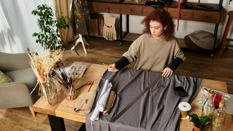 woman measuring fabric for DIY project