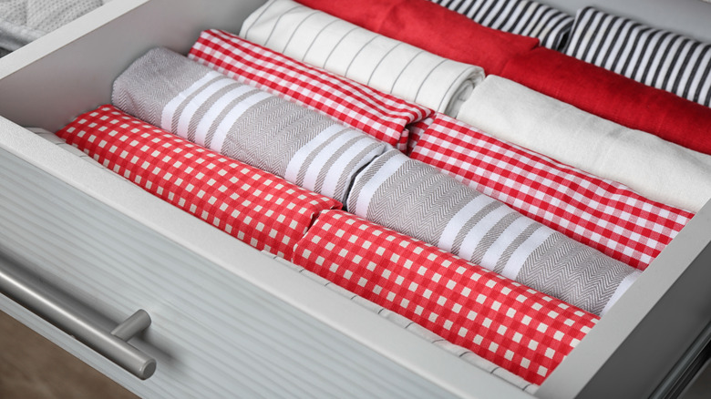 Folded dish towels in gray drawer