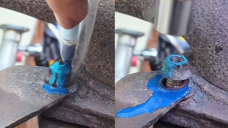 Melted crayon wax being used to loosen a stuck bolt