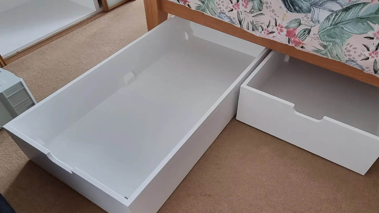 white drawers under the bed