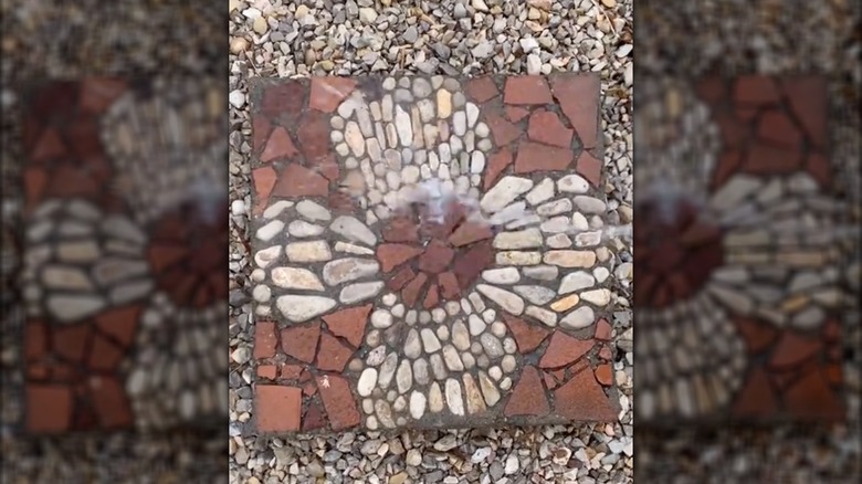 Photo of DIY mosaic paver with a flower pattern.
