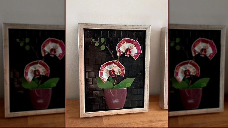 Wall art with teacups orchids and mosaic tiles.