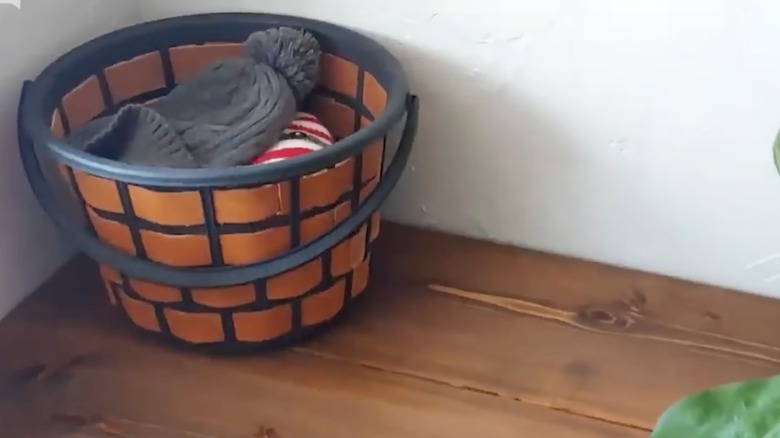 Plastic bin covered in leather straps