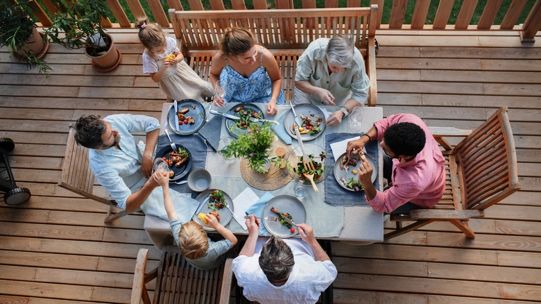 family sitting around patio table