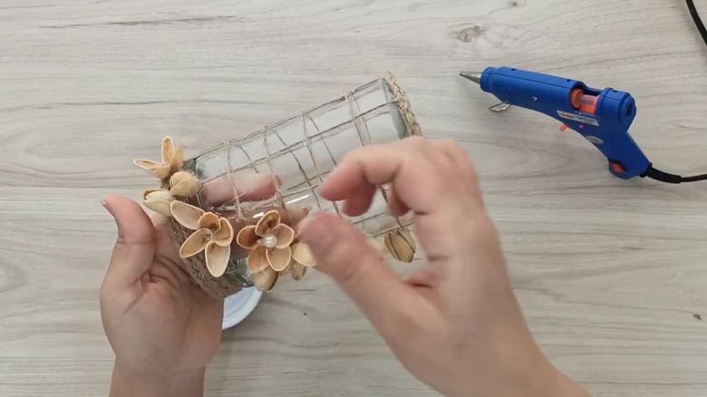 A crafter turns pistachio shells, twine, and an old jar into a stylish lantern