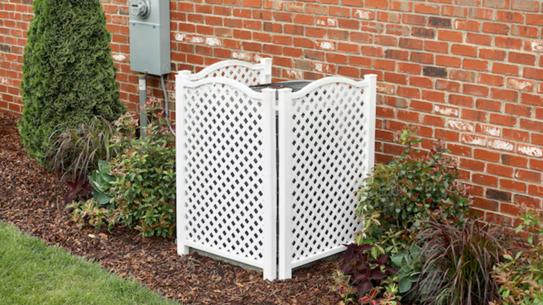 White privacy fence panels covering AC unit