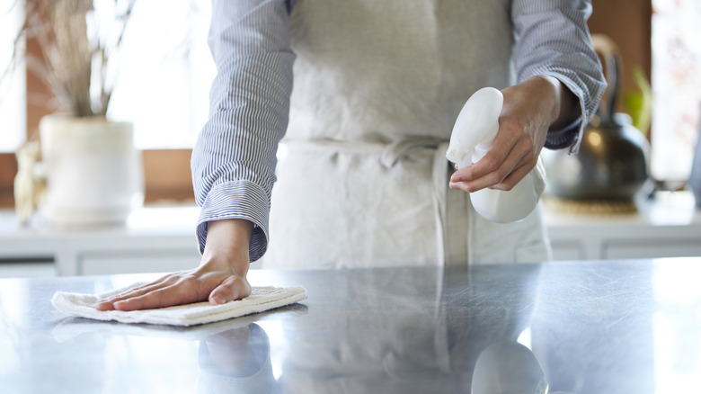 Person using spray bottle