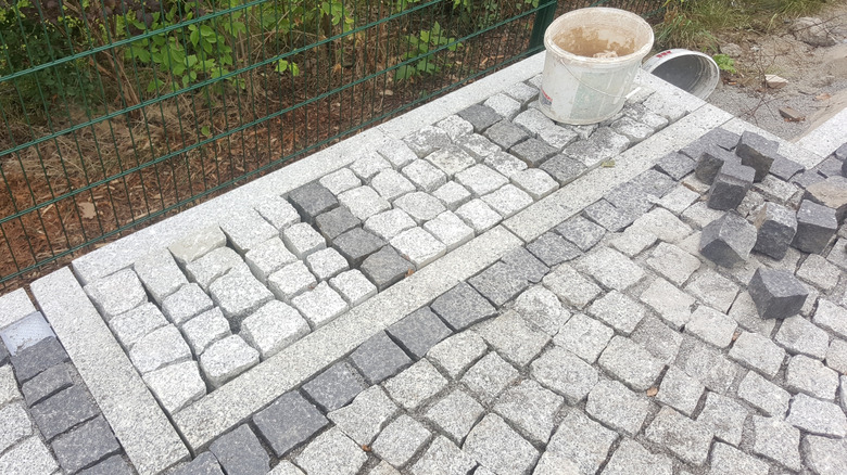 Partially completed garden path made of granite cobblestone
