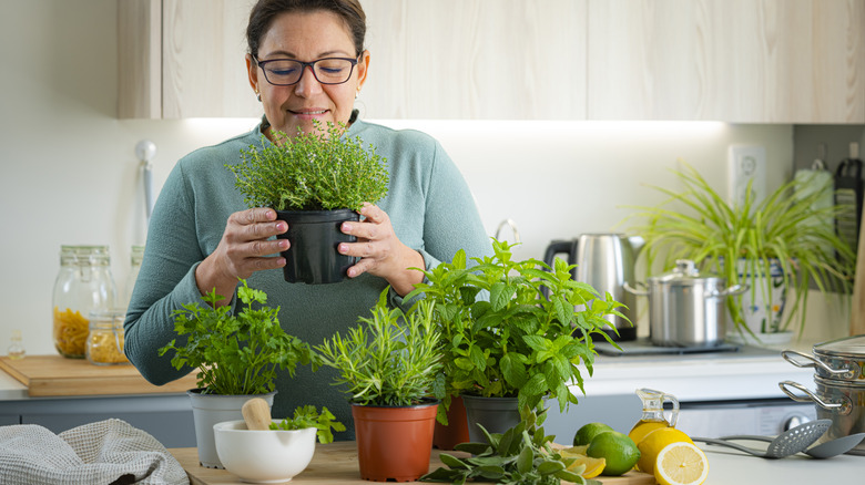 woman in kitchen with herbs