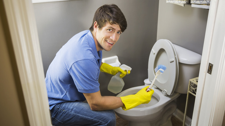 Person cleaning toilet
