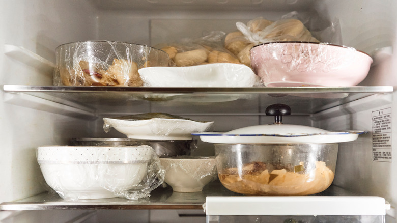Dishes stacked in fridge