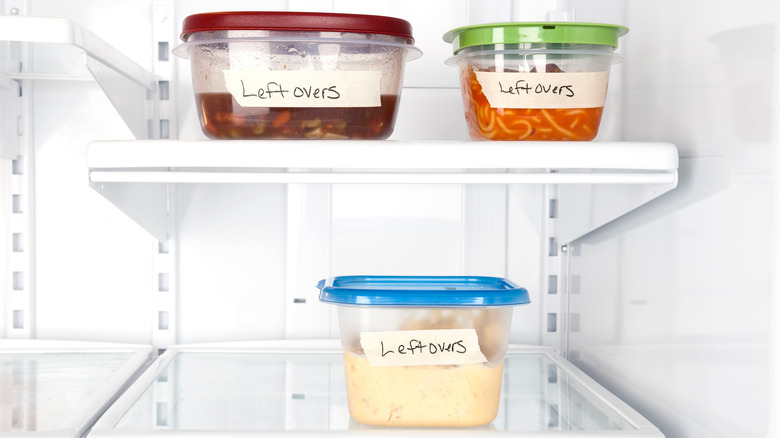 three plastic storage containers in refrigerator 