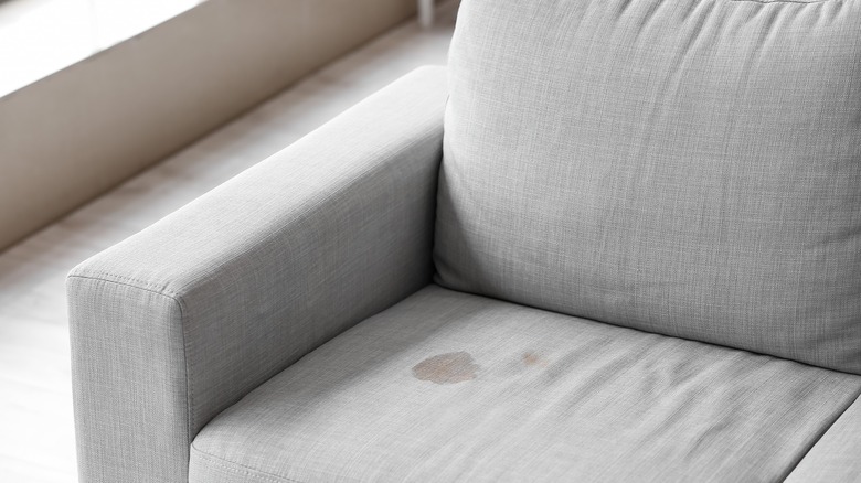 dark stain on gray couch