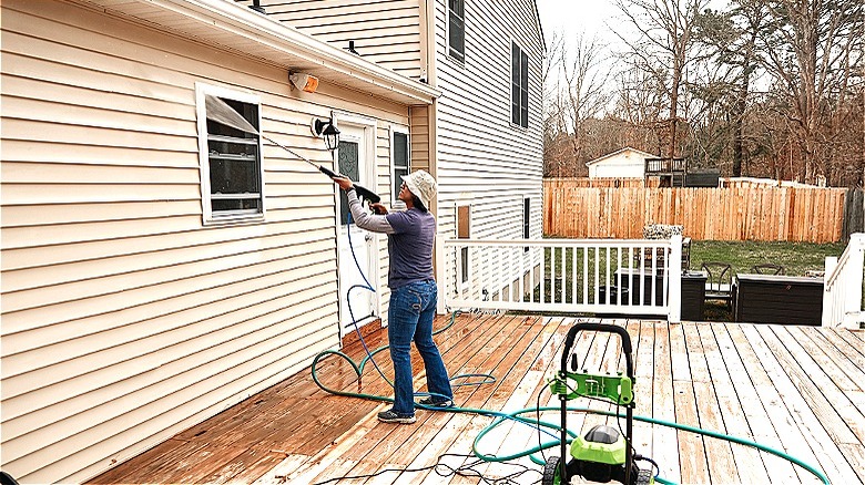person washing the siding
