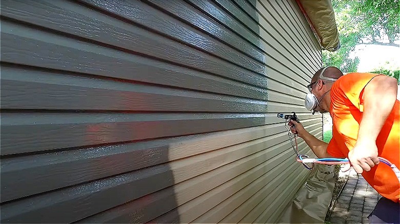 person painting siding