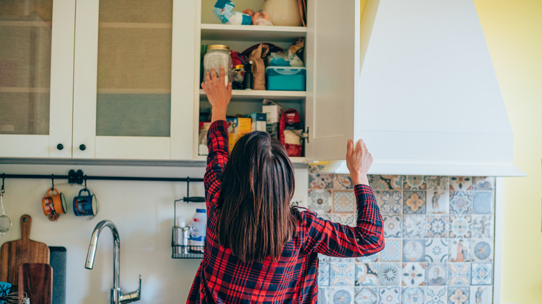 Woman organizing her kitchen storage