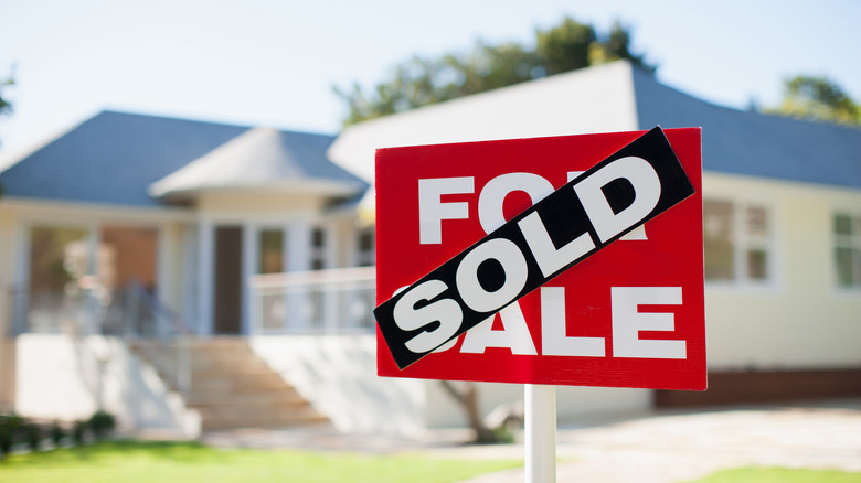 large home behind sold sign