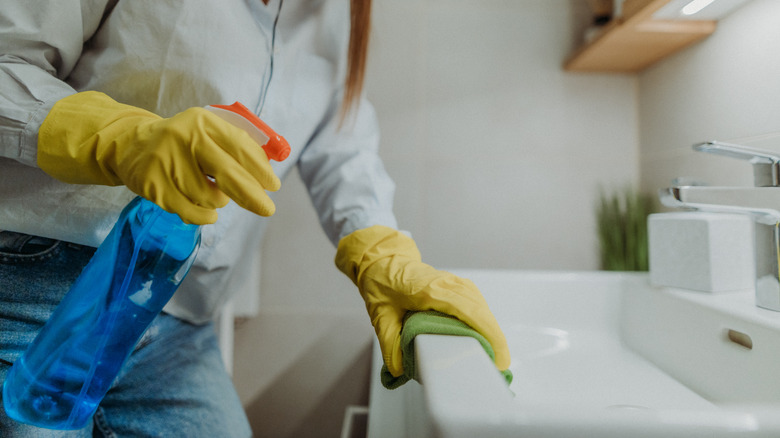 Woman cleaning bathroom
