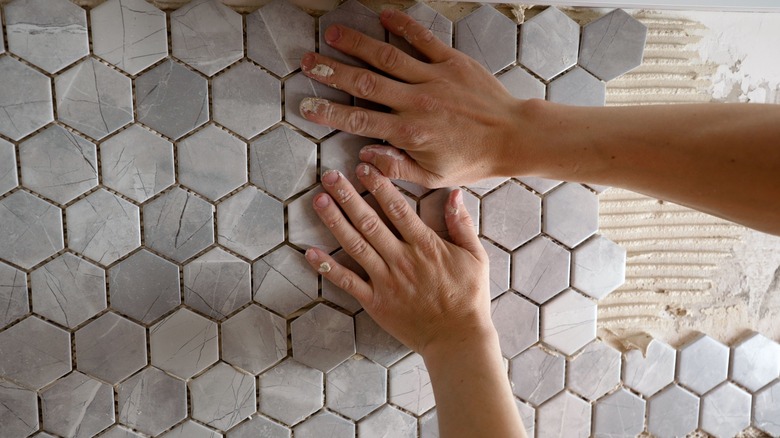 Person installing tile