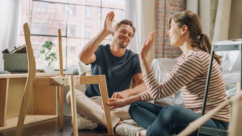 Couple assembles furniture together