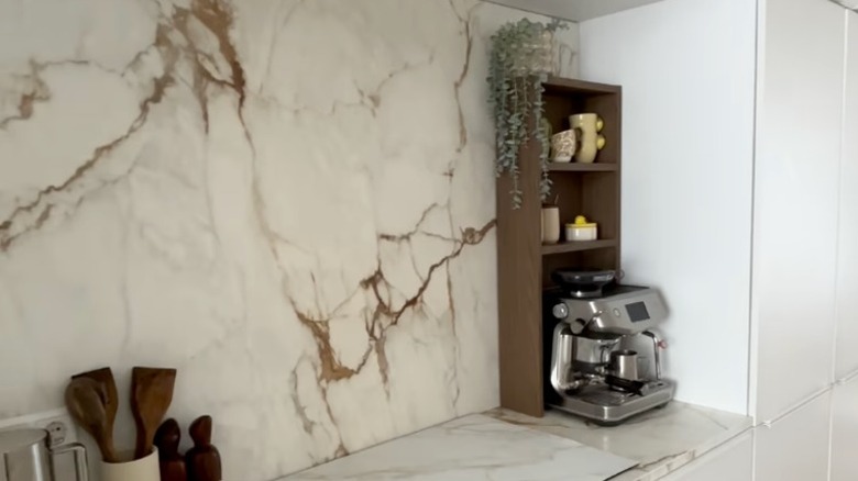 A small brown bookcase over a coffee maker
