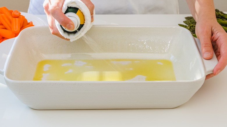 Spraying oil in dish