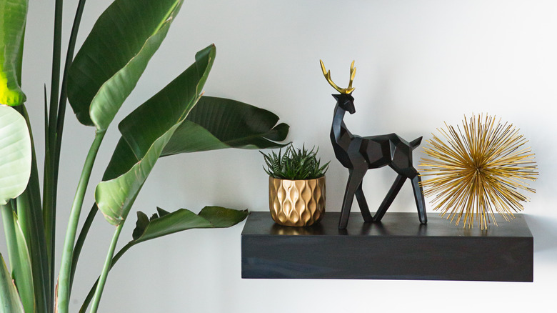 black floating shelf with decorations