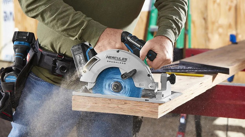 A man cutting lumber with the Hercules 20V cordless circular saw from Harbor Freight