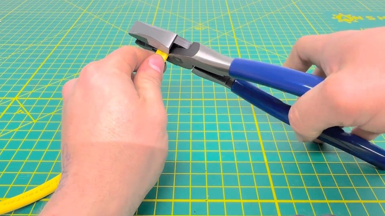 Person cutting wire with QUINN 9-Inch Linesman Pliers