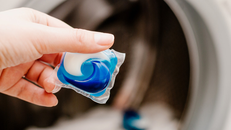 hand holding laundry pod