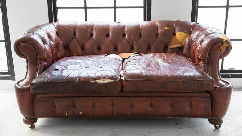 leather sofa with discoloration tears cracking