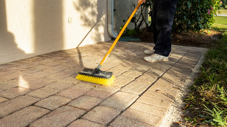 person cleaning patio pavers