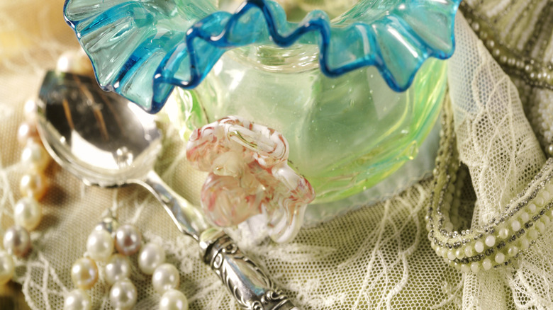 Glass antiques bowl with vintage collectibles.