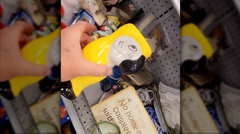 Hand holding a vintage tiki mug