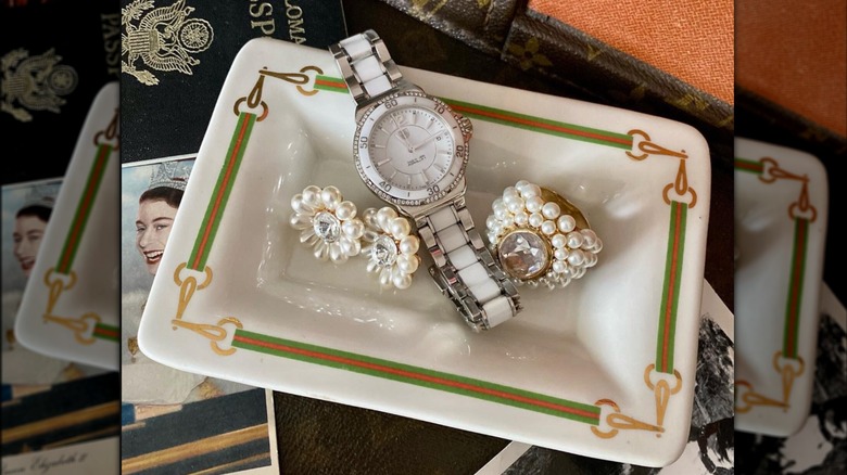 Vintage Gucci trinket tray with watch, ring, and earrings