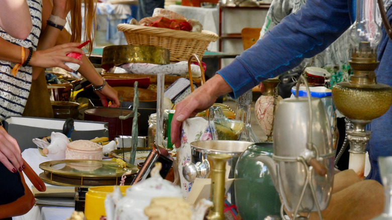 People shopping for thrifted dishes