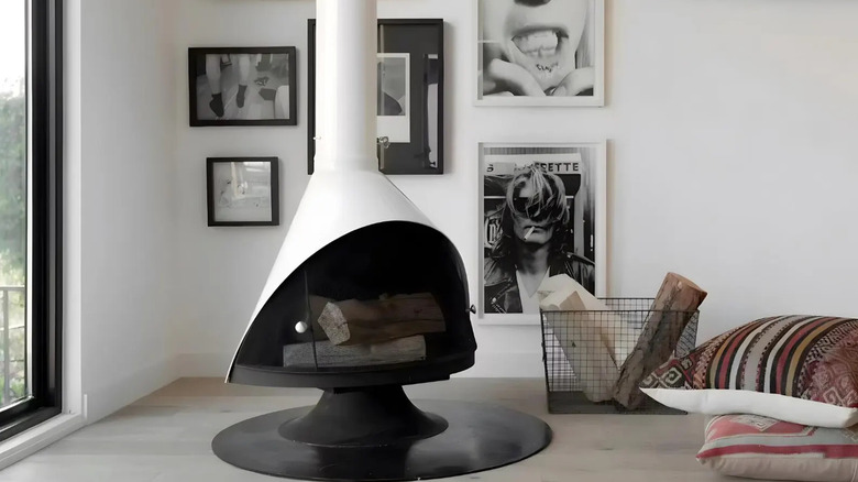 A white mid-century cone shaped fireplace.