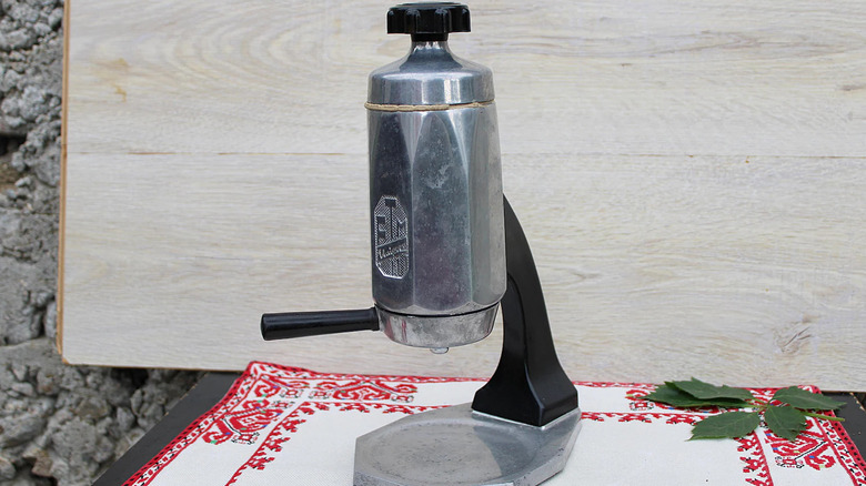 A vintage mid-century steel espresso maker.