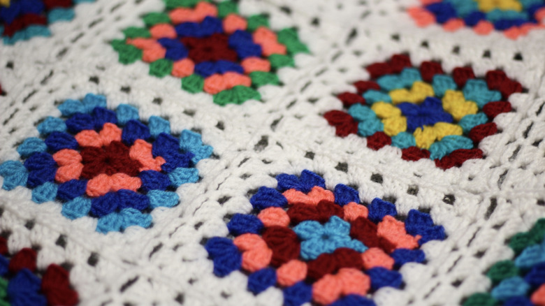 A crocheted granny square blanket