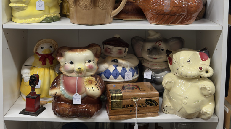 Vintage unique cookie jars on thrift store shelf