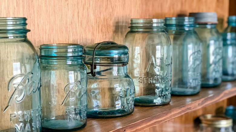 Vintage mason jars on a wooden shelf