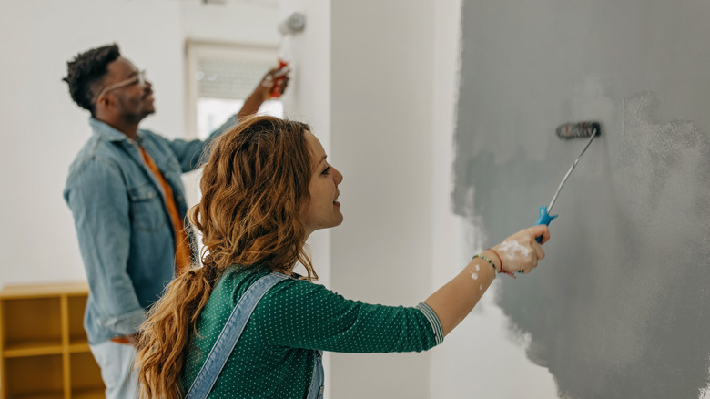 couple painting wall