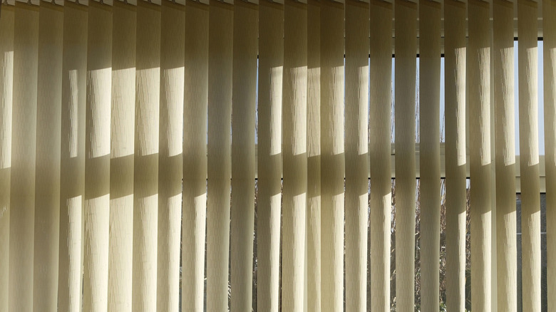 A bay window featuring vertical window blinds.
